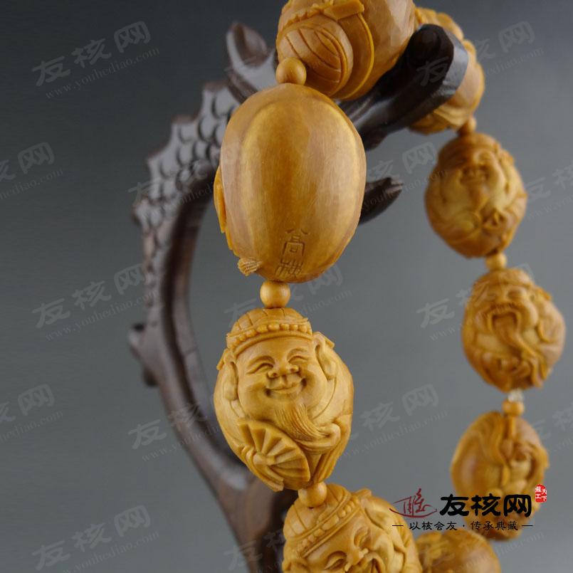 高梅 凤穿牡丹长串橄榄核雕 落款